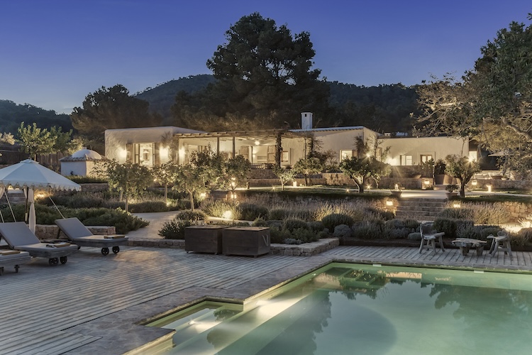 The pool and finca by night